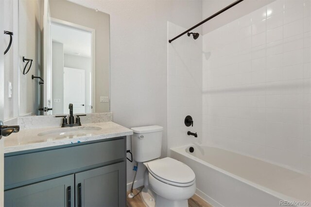 full bathroom featuring toilet, shower / washtub combination, and vanity