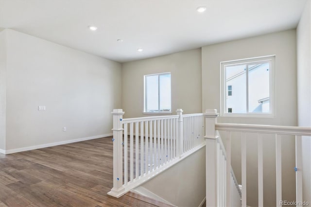 corridor featuring recessed lighting, an upstairs landing, baseboards, and wood finished floors