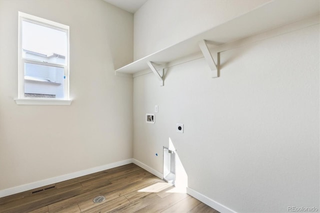 laundry area featuring visible vents, hookup for a washing machine, wood finished floors, laundry area, and hookup for an electric dryer