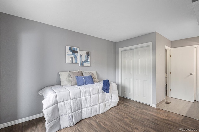 bedroom with hardwood / wood-style flooring and a closet