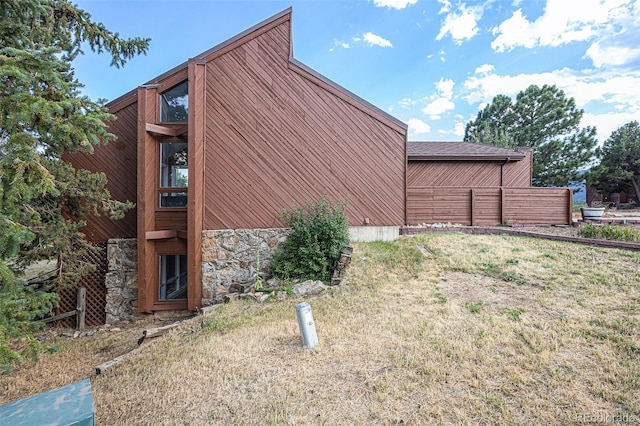 view of side of home featuring a lawn