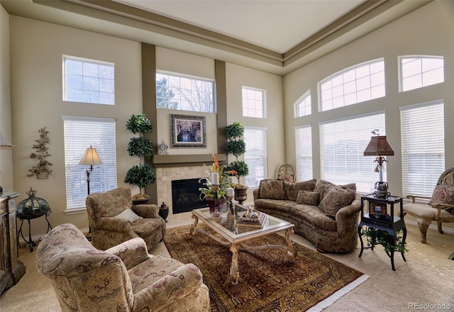 carpeted living room featuring a towering ceiling