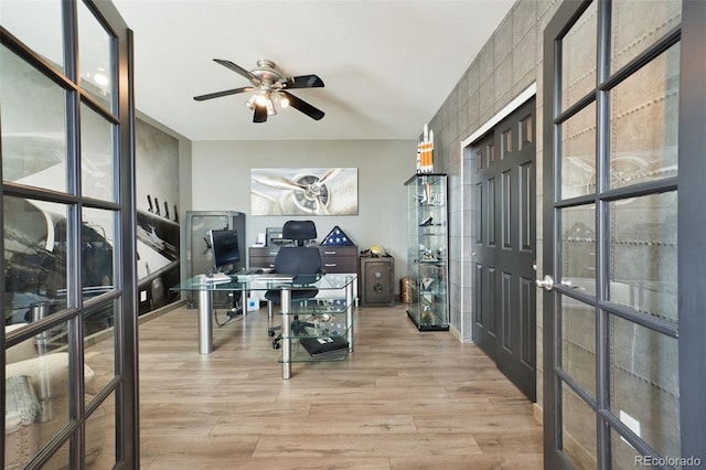 office with ceiling fan and light hardwood / wood-style flooring