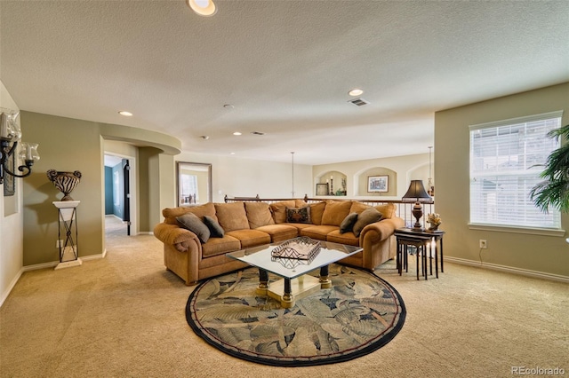 carpeted living room featuring a textured ceiling