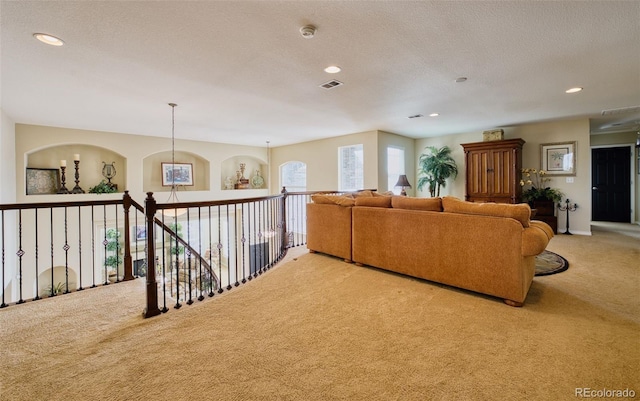 carpeted living room with a textured ceiling