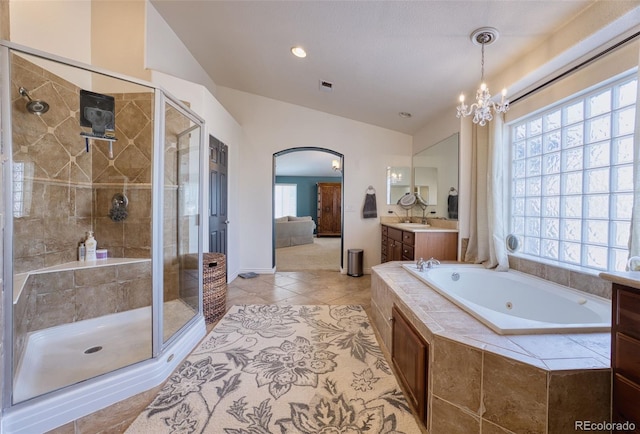 bathroom featuring an inviting chandelier, vaulted ceiling, vanity, independent shower and bath, and tile patterned flooring