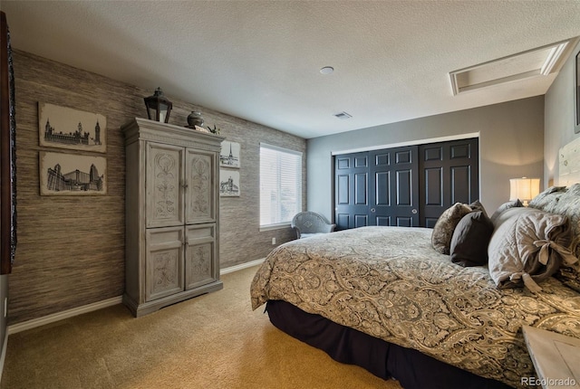 bedroom featuring light colored carpet, a closet, and a textured ceiling