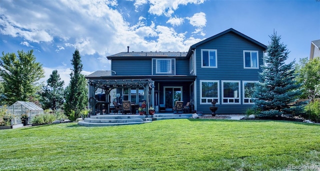 rear view of property featuring a pergola, an outdoor structure, and a lawn