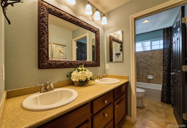 full bathroom with tile patterned floors, vanity, toilet, and shower / bath combo with shower curtain