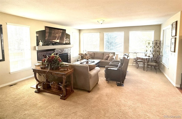 living area with light carpet, a fireplace, visible vents, and a textured ceiling