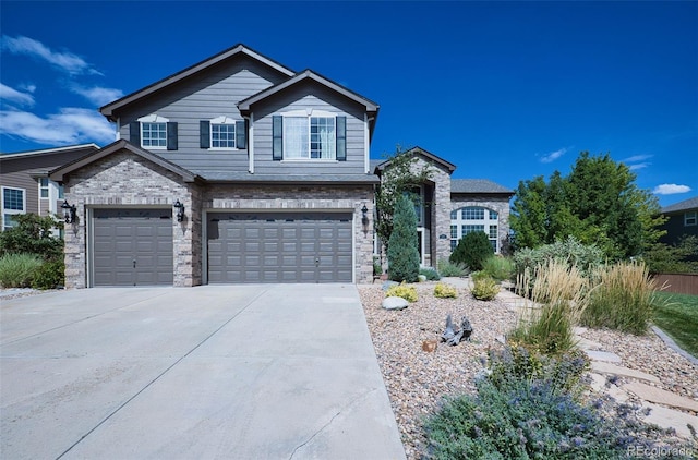 view of front facade featuring a garage, stone siding, and driveway