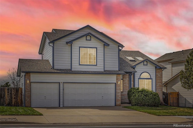 3823 S Uravan St, Aurora, CO 80013 - traditional-style home with concrete driveway, an attached garage, a shingled roof, and brick siding