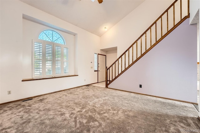 3823 S Uravan St, Aurora, CO 80013 - carpeted entrance foyer with stairs, baseboards, and high vaulted ceiling