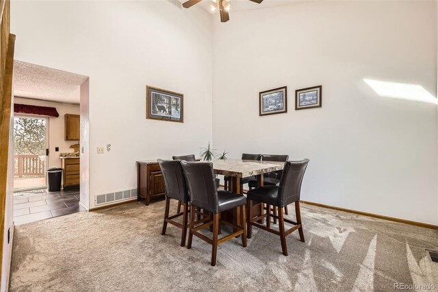 3823 S Uravan St, Aurora, CO 80013 - dining space featuring a ceiling fan, baseboards, carpet flooring, and a high ceiling