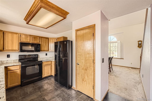 3823 S Uravan St, Aurora, CO 80013 - kitchen with black appliances, baseboards, and light stone counters