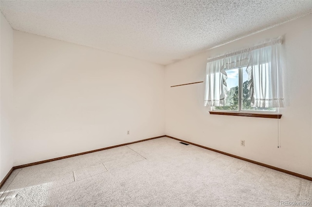 3823 S Uravan St, Aurora, CO 80013 - unfurnished room featuring light colored carpet, a textured ceiling, and baseboards