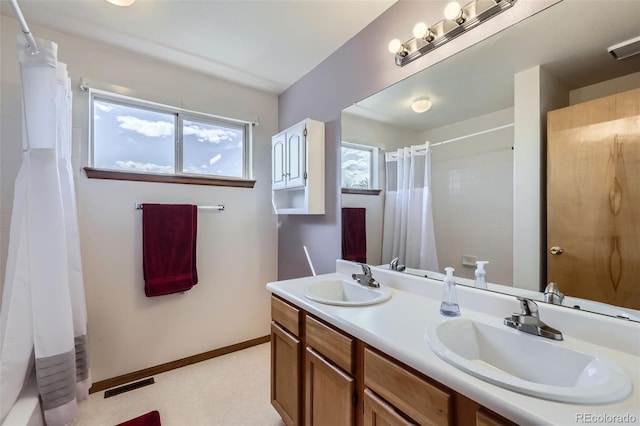 3823 S Uravan St, Aurora, CO 80013 - bathroom with double vanity, curtained shower, and baseboards