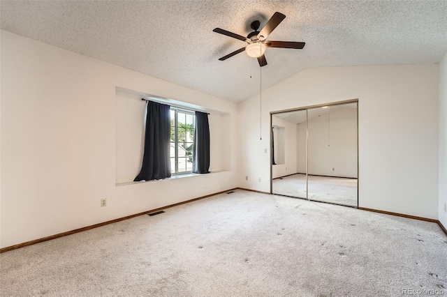 3823 S Uravan St, Aurora, CO 80013 - unfurnished bedroom with carpet flooring, vaulted ceiling, baseboards, a closet, and a textured ceiling