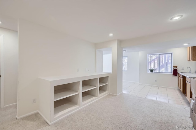 3823 S Uravan St, Aurora, CO 80013 - basement with a sink, light colored carpet, recessed lighting, light tile patterned floors, and baseboards