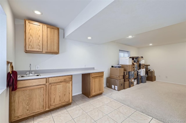 3823 S Uravan St, Aurora, CO 80013 - kitchen featuring a sink, light colored carpet, recessed lighting, light countertops, and light tile patterned floors