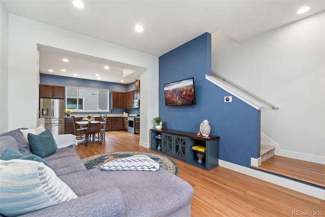 7808 W 43rd Pl, Wheat Ridge, CO 80033 - living room featuring light wood-style flooring, recessed lighting, stairs, and baseboards