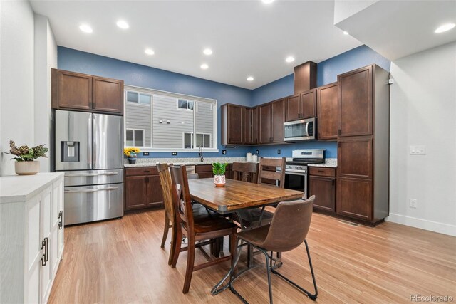 7808 W 43rd Pl, Wheat Ridge, CO 80033 - kitchen with appliances with stainless steel finishes, light wood-style floors, light countertops, and recessed lighting