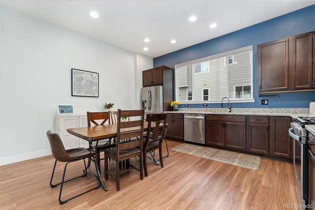 7808 W 43rd Pl, Wheat Ridge, CO 80033 - kitchen featuring stainless steel appliances, dark brown cabinetry, light wood-style flooring, recessed lighting, and a sink