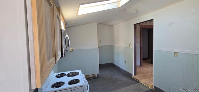 4635 Teller St, Wheat Ridge, CO 80033 - hall featuring vaulted ceiling, dark wood-style floors, and a wainscoted wall