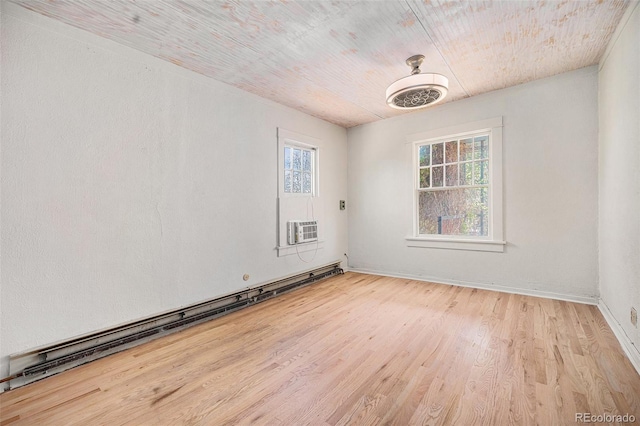 4635 Teller St, Wheat Ridge, CO 80033 - unfurnished room with a baseboard heating unit, wood finished floors, baseboards, and wooden ceiling