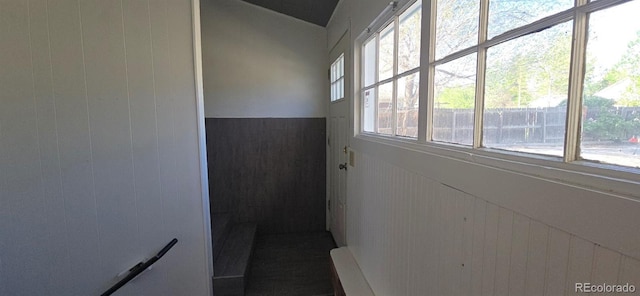 4635 Teller St, Wheat Ridge, CO 80033 - corridor with a wainscoted wall, wooden walls, and vaulted ceiling