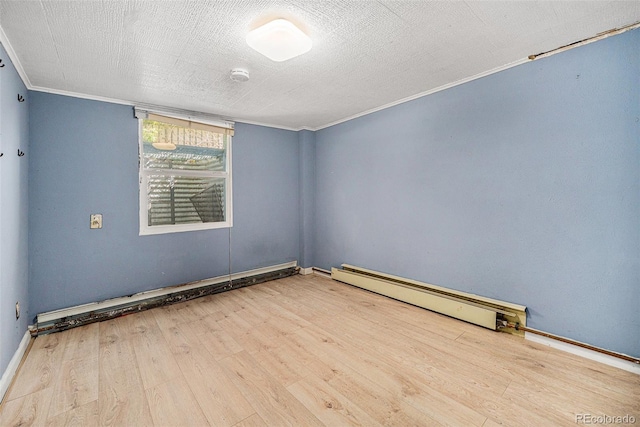 4635 Teller St, Wheat Ridge, CO 80033 - empty room featuring a baseboard radiator, wood finished floors, crown molding, a smoke detector, and baseboards