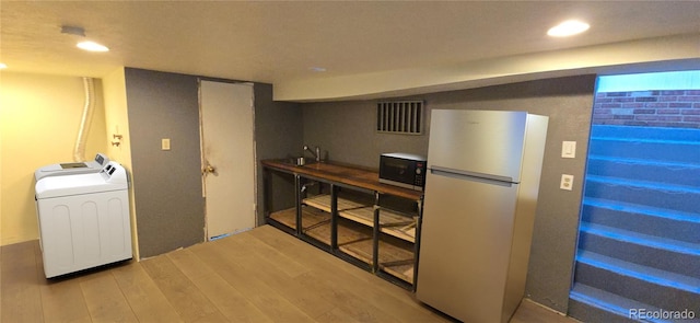 4635 Teller St, Wheat Ridge, CO 80033 - kitchen featuring freestanding refrigerator, washer / clothes dryer, wood finished floors, and recessed lighting