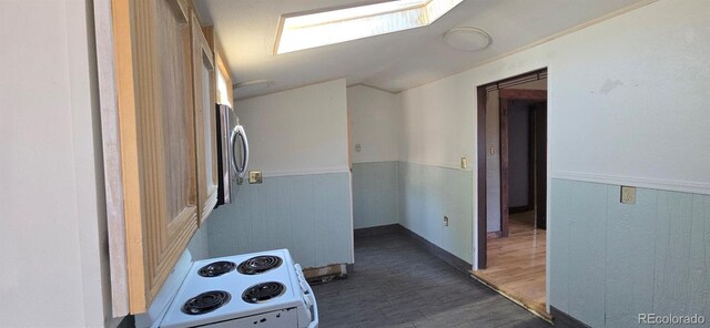 4635 Teller St, Wheat Ridge, CO 80033 - hallway with lofted ceiling, dark wood-style floors, and wainscoting