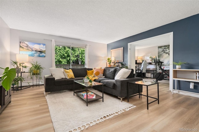 7040 E Girard Ave Unit 207, Denver, CO 80224 - living room with light wood-type flooring, a textured ceiling, and baseboard heating
