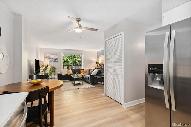 7040 E Girard Ave Unit 207, Denver, CO 80224 - dining area featuring a ceiling fan, light wood-style floors, and baseboards