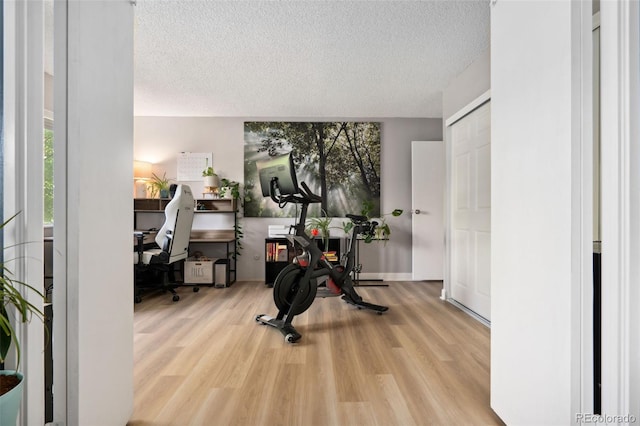 7040 E Girard Ave Unit 207, Denver, CO 80224 - exercise area with a textured ceiling and wood finished floors