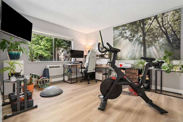 7040 E Girard Ave Unit 207, Denver, CO 80224 - exercise area with wood finished floors, a textured ceiling, and baseboards
