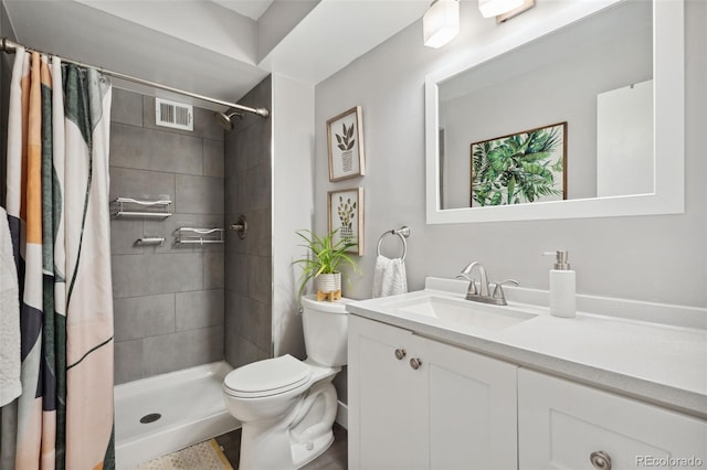 7040 E Girard Ave Unit 207, Denver, CO 80224 - bathroom featuring toilet, vanity, and tiled shower