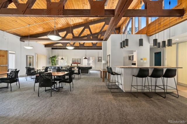 7040 E Girard Ave Unit 207, Denver, CO 80224 - carpeted dining area featuring a high ceiling and wooden ceiling with exposed beams