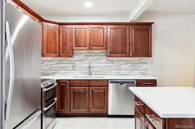 kitchen with tasteful backsplash, sink, and stainless steel appliances