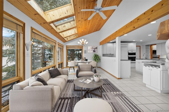 tiled living room with vaulted ceiling with skylight, ceiling fan with notable chandelier, wooden ceiling, and sink