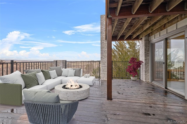 wooden deck with an outdoor living space with a fire pit