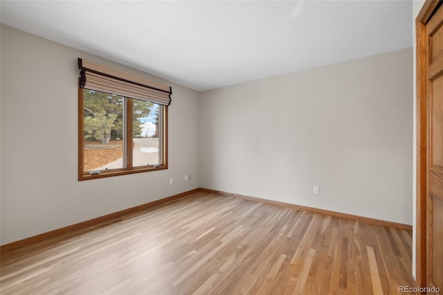 unfurnished room with light wood-type flooring