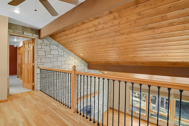 corridor with lofted ceiling with beams, hardwood / wood-style floors, and wood ceiling