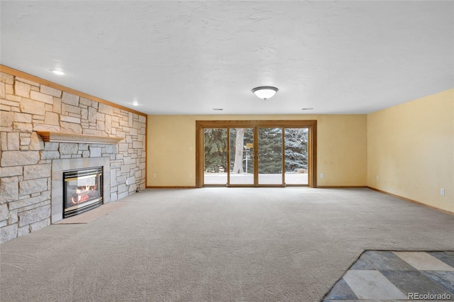 unfurnished living room with carpet and a fireplace