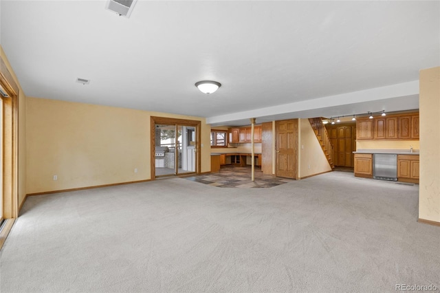 unfurnished living room featuring light carpet