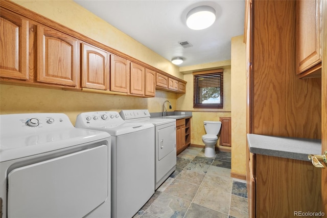 clothes washing area with washing machine and clothes dryer