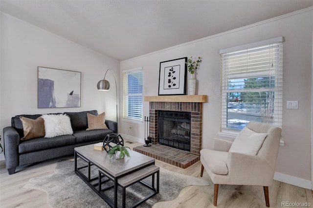 living room with a brick fireplace, hardwood / wood-style flooring, and plenty of natural light