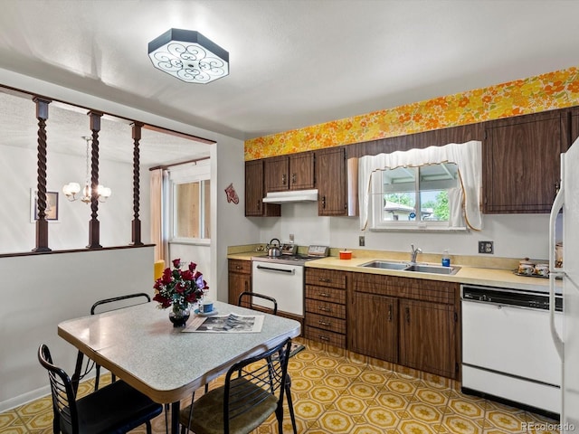 3018 S Depew St, Denver, CO 80227 - kitchen featuring white appliances, a sink, light countertops, and under cabinet range hood