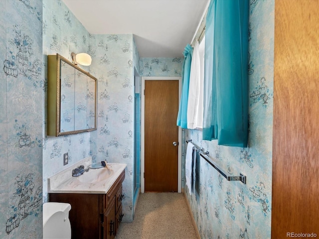 3018 S Depew St, Denver, CO 80227 - bathroom with wallpapered walls, vanity, and toilet